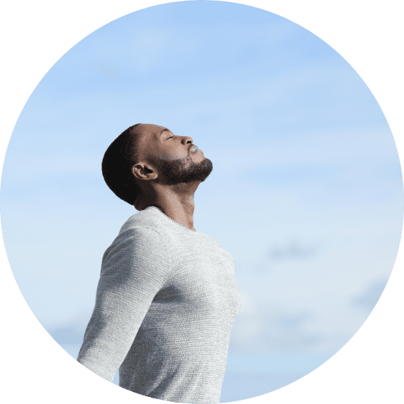 A man with his eyes closed looking up.